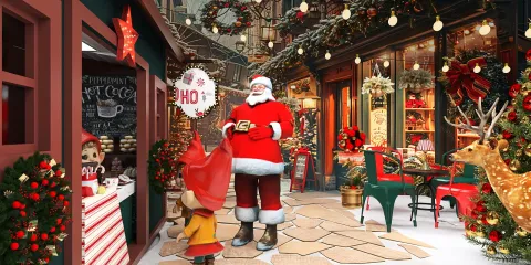A festive outdoor scene featuring Santa Claus greeting a child in a Christmas market, decorated with lights and holiday ornaments, capturing the joyful spirit of a winter celebration, showcasing an inviting atmosphere for interior decor inspiration.