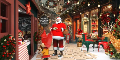 Christmas street scene featuring a festive outdoor market with Santa Claus greeting a child, decorated with lights and ornaments, capturing a holiday spirit in a vibrant setting.