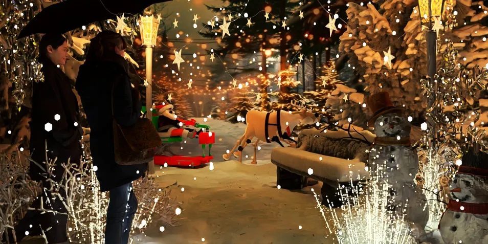 people enjoying a festive outdoor winter scene featuring a snowman, decorated trees, and holiday decorations, showcasing Christmas interior decor design.
