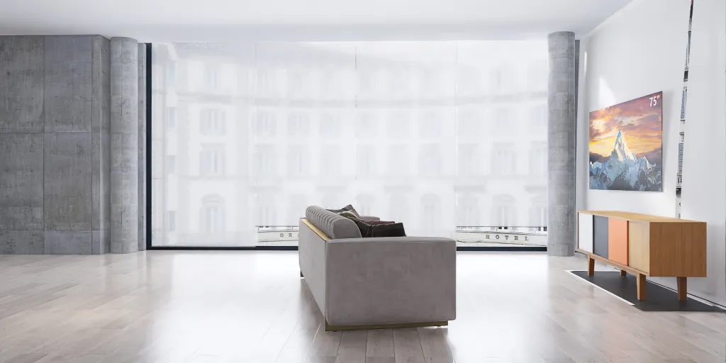 a large white couch in a room with a large window 