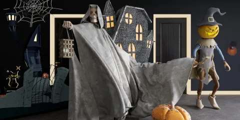 Halloween decorations featuring a ghostly figure and a pumpkin-headed character creating a spooky atmosphere in a themed interior design space; showcasing Homestyler's AR virtual placement feature for immersive design experiences.
