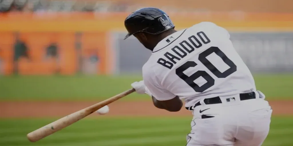 a baseball player swinging a bat at a ball 