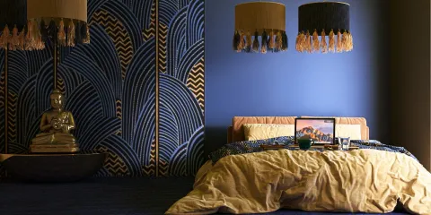 Buddha statue and modern bed design showcasing a unique wall pattern and lighting fixtures in a cozy bedroom atmosphere with a focus on interior decor.