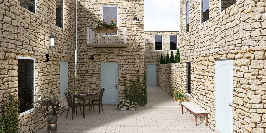 a small courtyard with a stone wall and a brick building 