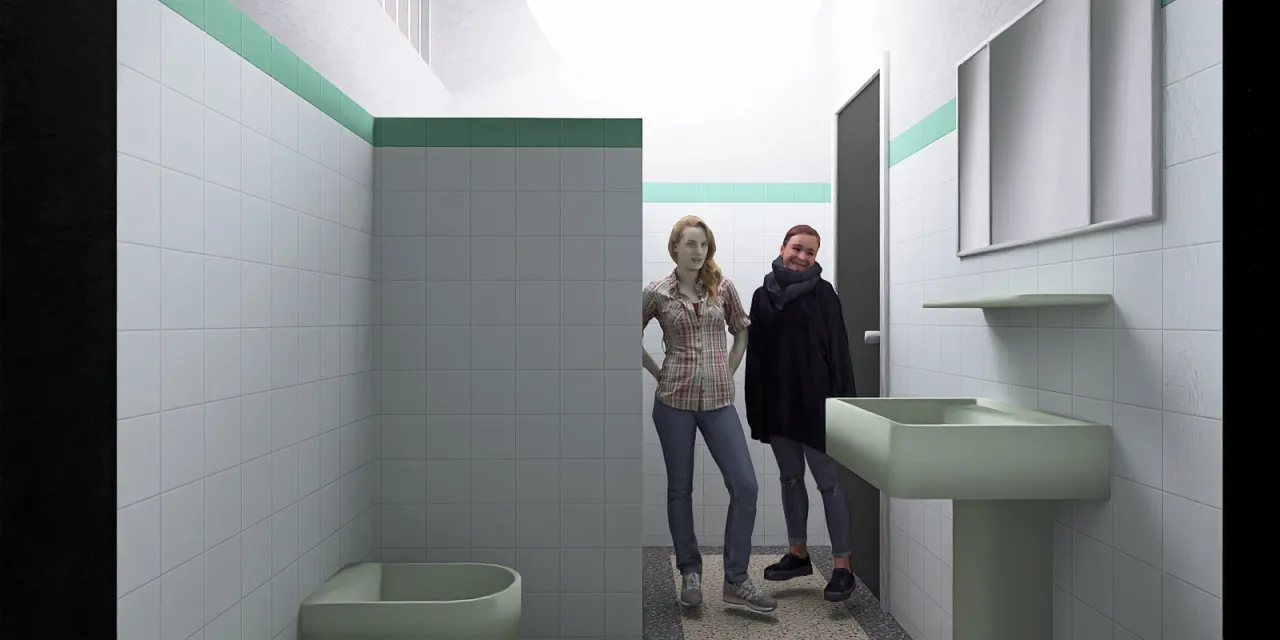 a man and woman standing in a bathroom 