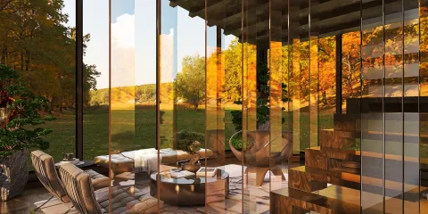 modern interior lounge area with panoramic glass walls showcasing a scenic outdoor view, featuring cozy furniture arrangement and autumn colors, utilizing Homestyler's real-time 3D rendering for design visualization.