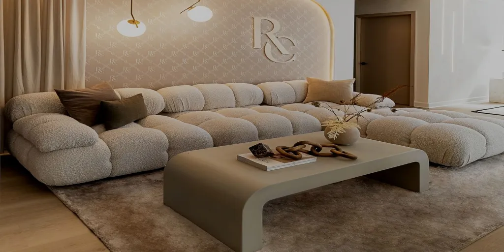 a living room with a couch, coffee table, and a table with a bookcase 