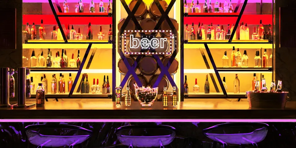 Stylish bar setup with vibrant lighting and modern shelves displaying various beverages, showcasing a contemporary interior design, featuring Homestyler's real-time 3D rendering for immersive design previews.
